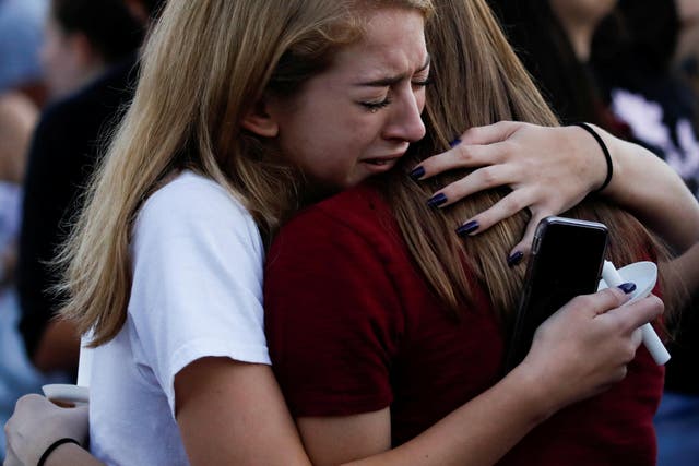Students mourn during a candlelight vigil for victims of a shooting at Marjory Stoneman Douglas High School, in Parkland, Florida