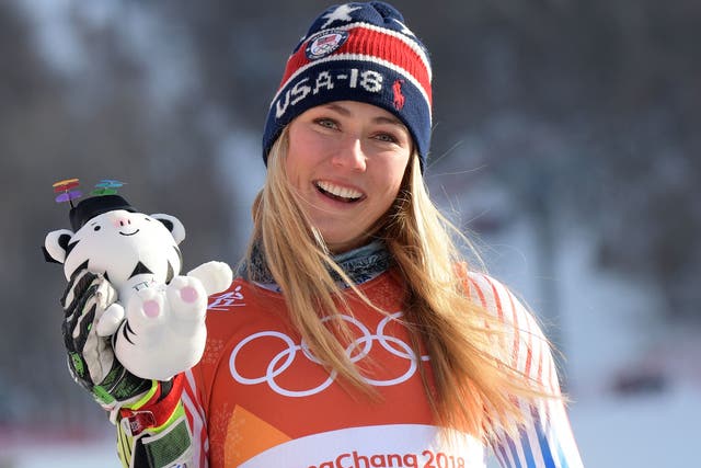 Mikaela Shiffrin holds up her Soohorang mascot after winning the women's Giant Slalom
