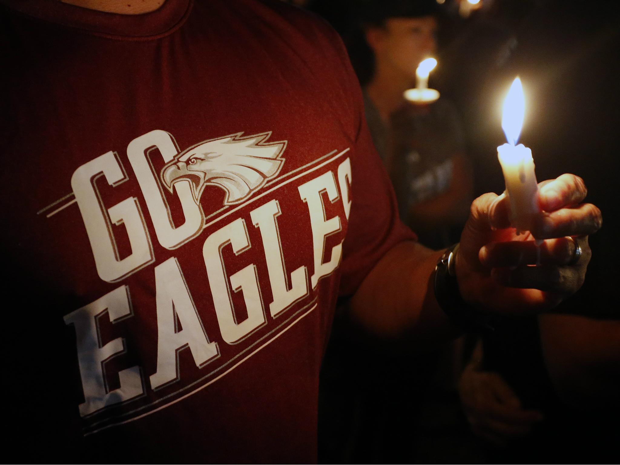 Thousands of mourners attend a candlelight vigil for victims of the Marjory Stoneman Douglas High School shooting in Parkland, Florida on 15 February 2018