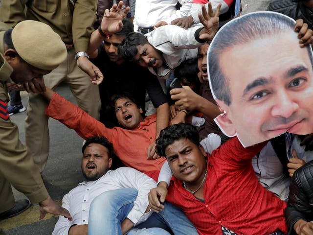 An activist of the youth wing of India’s main opposition Congress party holds a cut-out with an image of billionaire jeweller Nirav Modi during a protest in New Delhi last month
