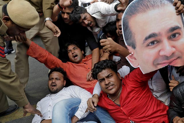 An activist of the youth wing of India’s main opposition Congress party holds a cut-out with an image of billionaire jeweller Nirav Modi during a protest in New Delhi last month