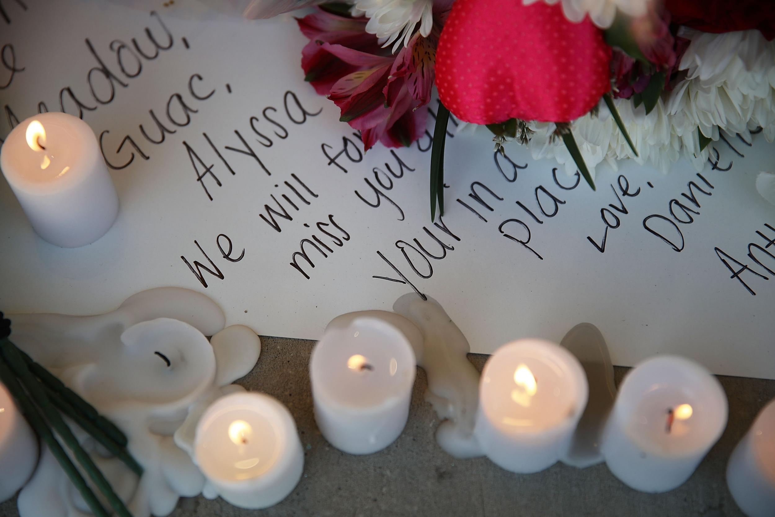 A note is seen left in a memorial setup during a service for the victims of the shooting at Marjory Stoneman Douglas High Schoo