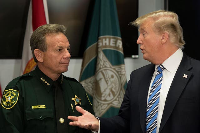 US President Donald Trump speaks with Broward County Sheriff Scott Israel  while visiting first responders at Broward County Sheriff's Office