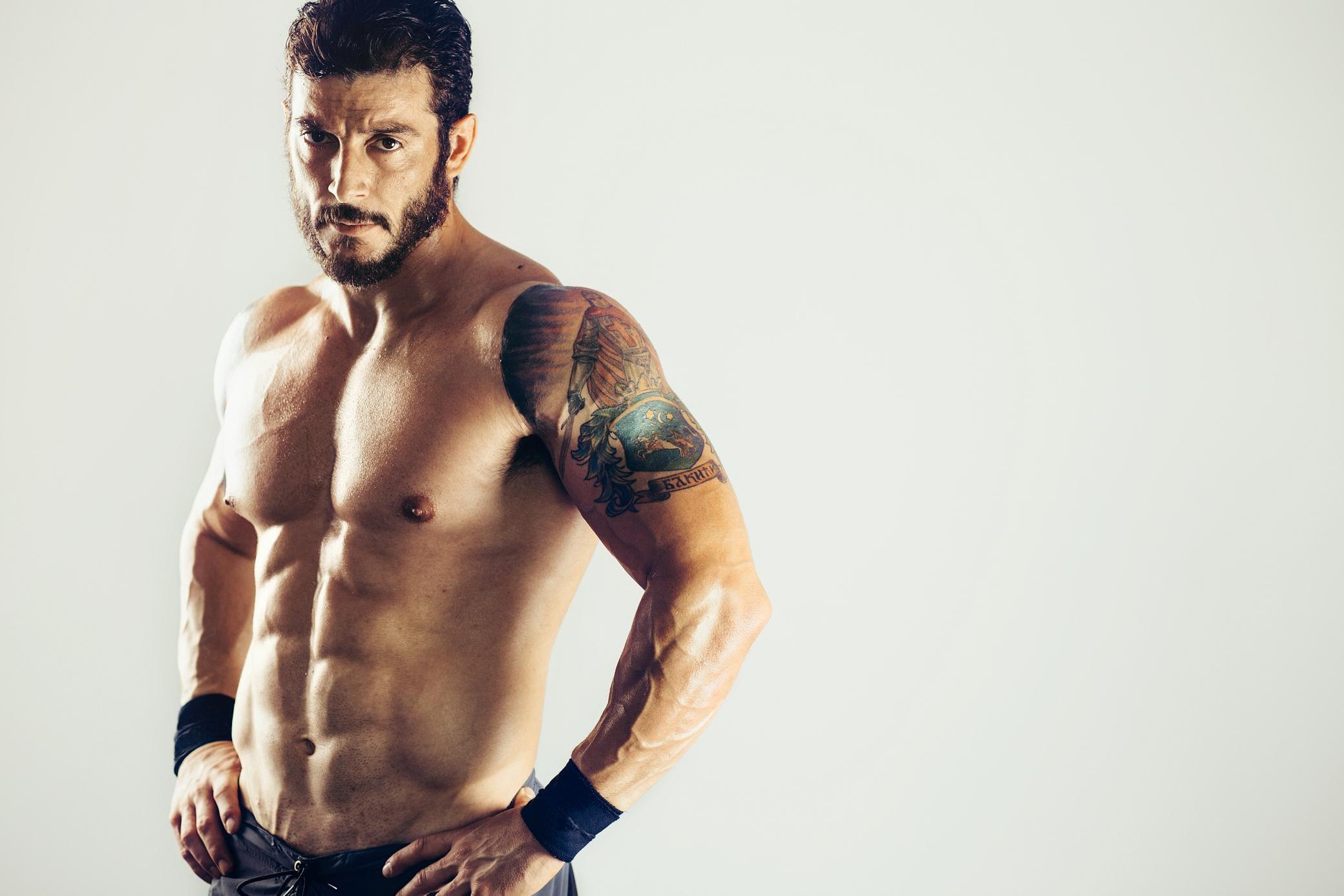 Bodycare with Fitness and Sport. Tattooed Man Show Muscular Torso.  Sportsman with Six Pack and Ab Stock Image - Image of muscle, hispanic:  150852279