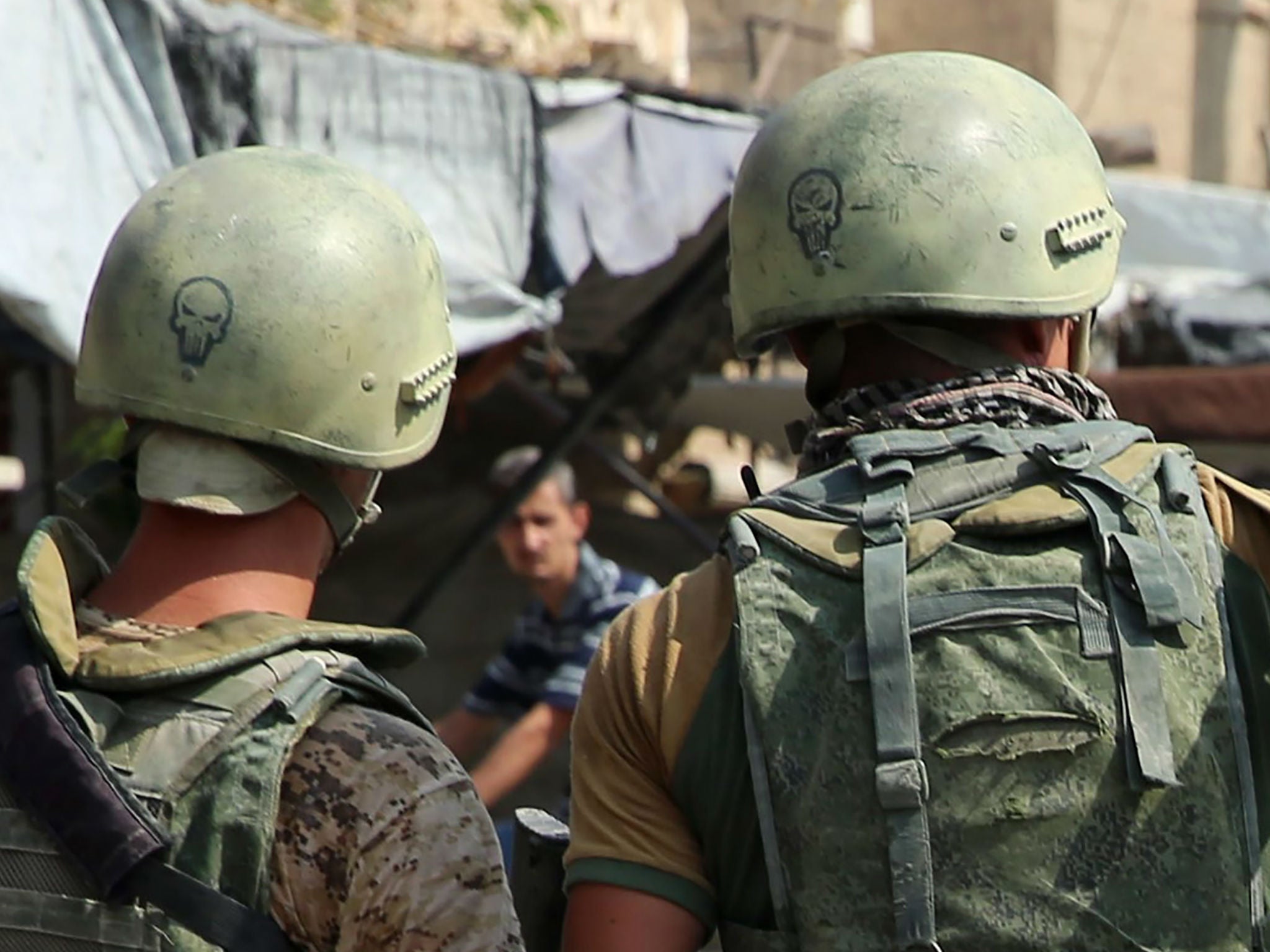 Russian soldiers on guard in Syria's eastern city of Deir Ezzor. The Kremlin says it does not track the presence of other Russian nationals in the country