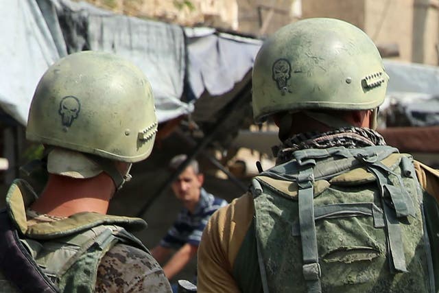 Russian soldiers on guard in Syria's eastern city of Deir Ezzor. The Kremlin says it does not track the presence of other Russian nationals in the country