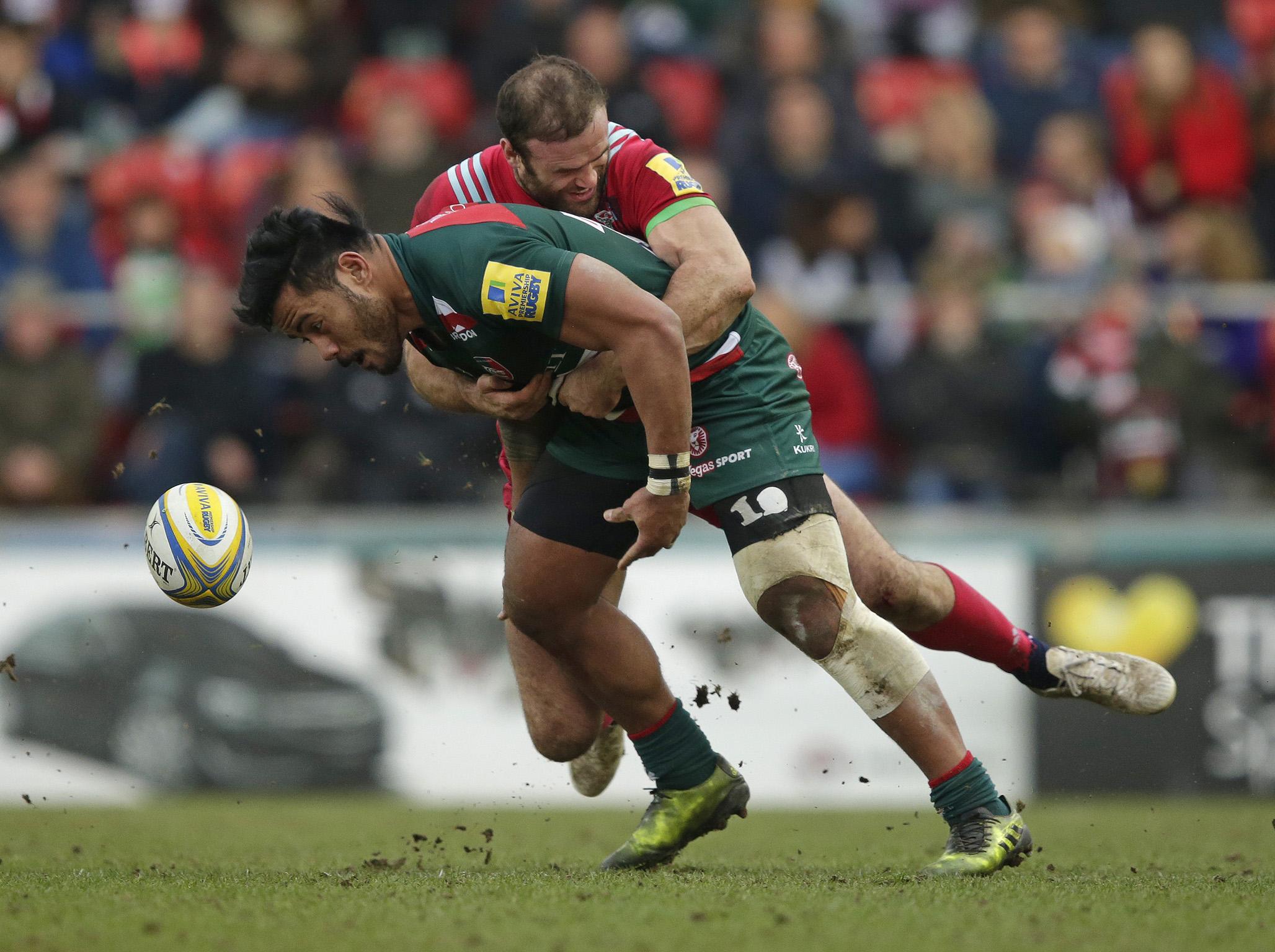 Manu Tuilagi is crunched by opposite centre Jamie Roberts