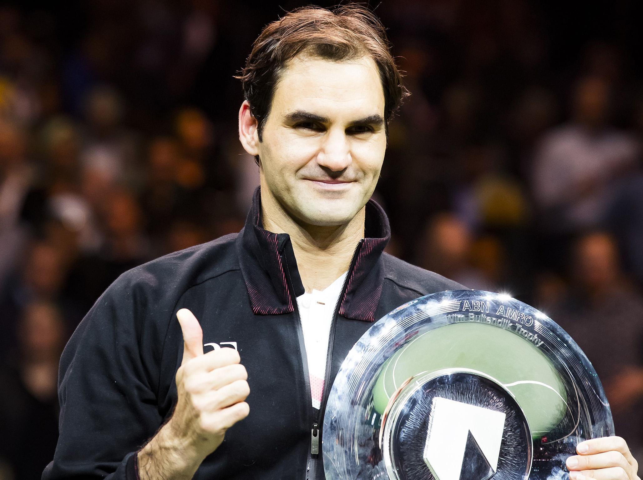Roger Federer celebrates with the trophy in Rotterdam