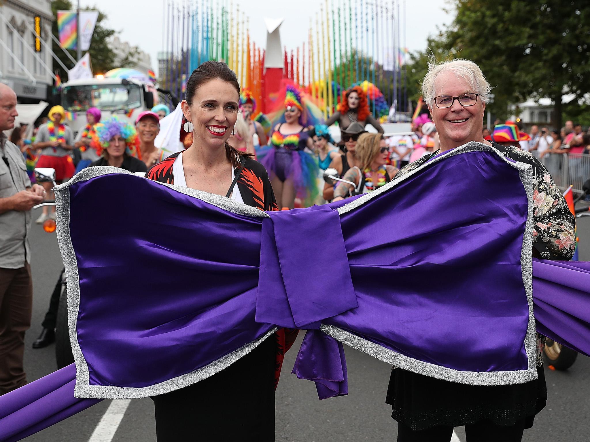 New Zealand Prime Minister Jacinda Ardern cuts the purple ribbon