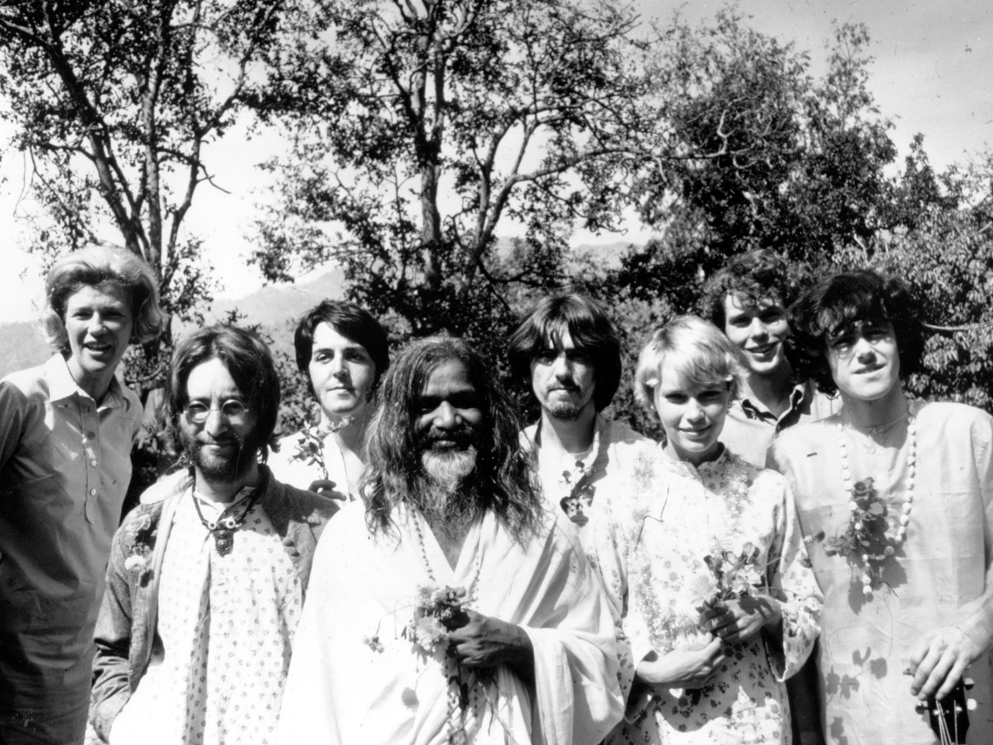 Maharishi Mahesh Yogi (centre) with Lennon, McCartney, Harrison, Mia Farrow, Donovan and others at the guru's academy in Rishikesh, India, in 1968