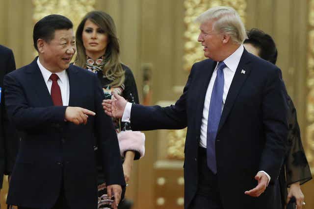 US President Donald Trump and China's President Xi Jinping arrive at a state dinner at the Great Hall of the People