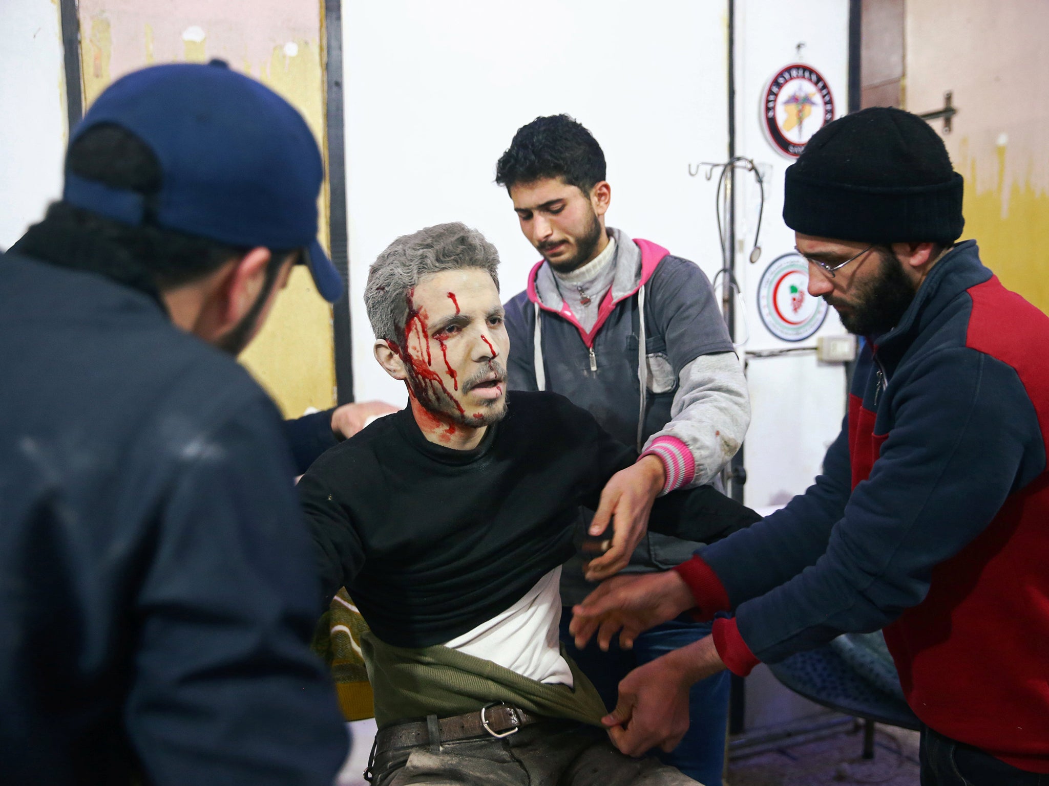 An injured man covered with blood at a medical point in the besieged town of Douma, Eastern Ghouta, Damascus (REUTERS/Bassam Khabieh)