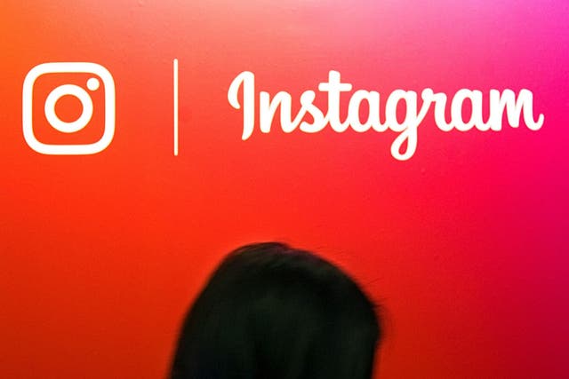 A visitor passes by the Instagram application logo at the Young Entrepreneurs fair in Paris, France, February 7, 2018