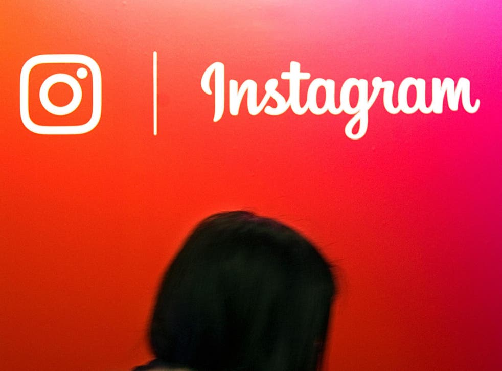 A visitor passes by the Instagram application logo at the Young Entrepreneurs fair in Paris, France, February 7, 2018