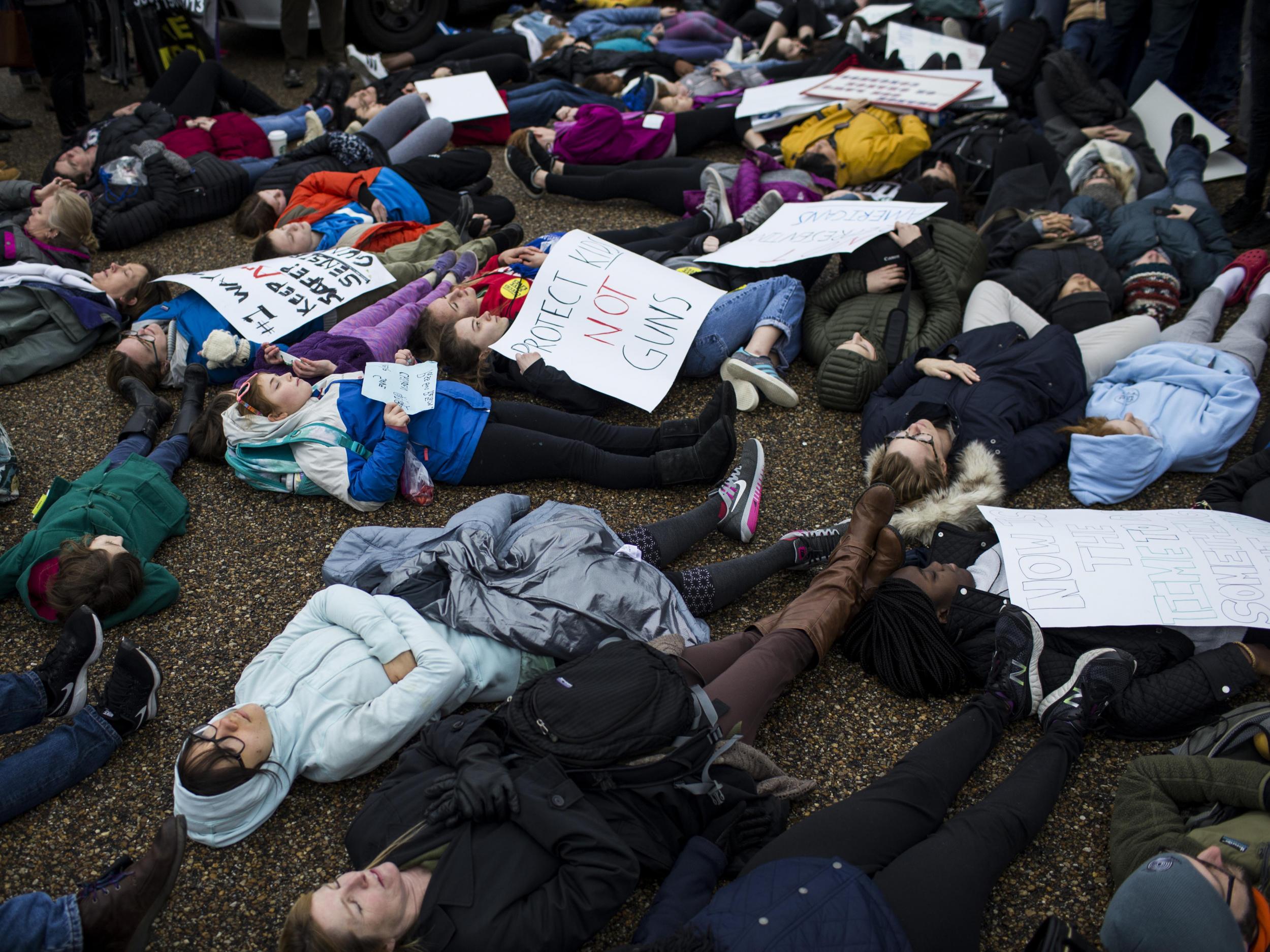 Demonstrators lie on the ground a "lie-in" protest near the White House supporting gun control reform