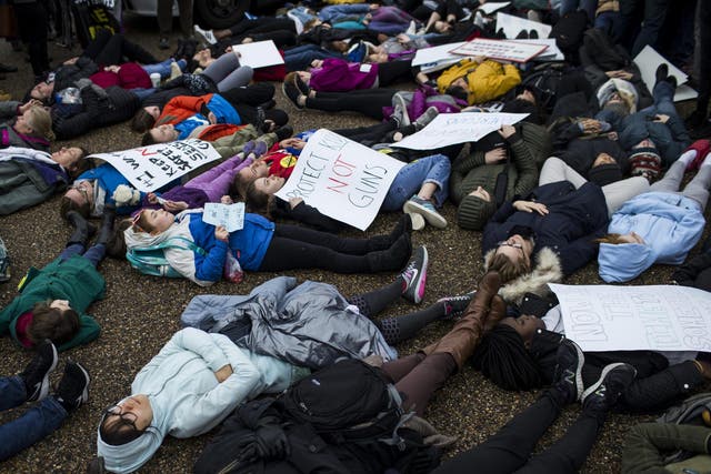 Demonstrators lie on the ground a "lie-in" protest near the White House supporting gun control reform