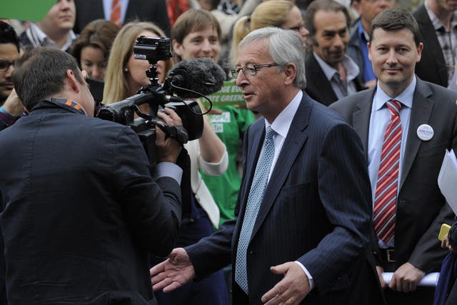 Martin Selmayr (right) stands off camera as Jean-Claude Juncker speaks to journalists