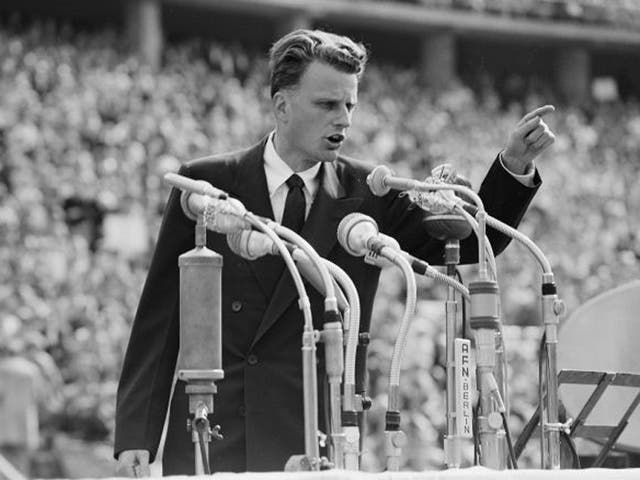 In this June 27, 1954 file photo, Evangelist Billy Graham speaks to over 100,000 people at the Olympic Stadium in Berlin, Germany