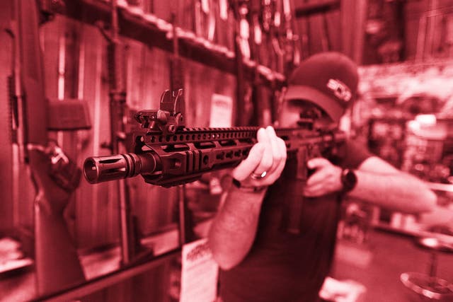 Dordon Brack, aims a semi-automatic AR-15 that is for sale at Good Guys Guns Range on February 15, 2018 in Orem, Utah
