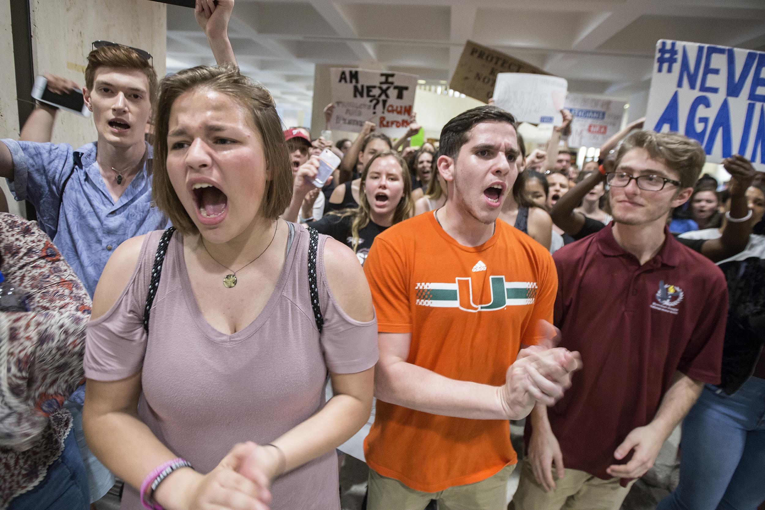 Students chant protest outside the Florida House of Representatives chamber