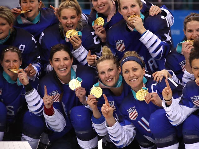 The US women's ice hockey team show off their gold medals