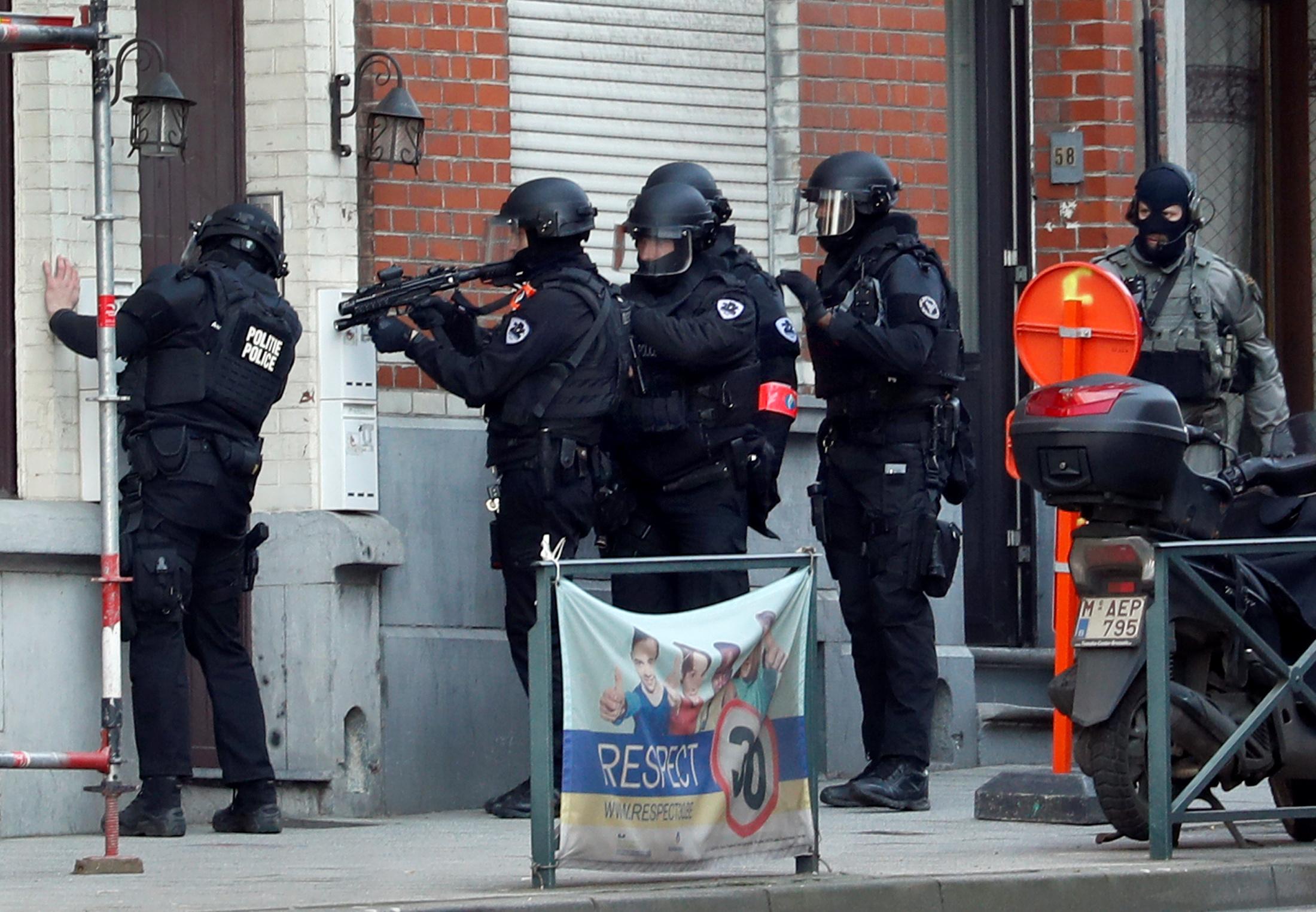 Belgian police special forces prepare to enter a building after an area of the Forest commune was put on lockdown