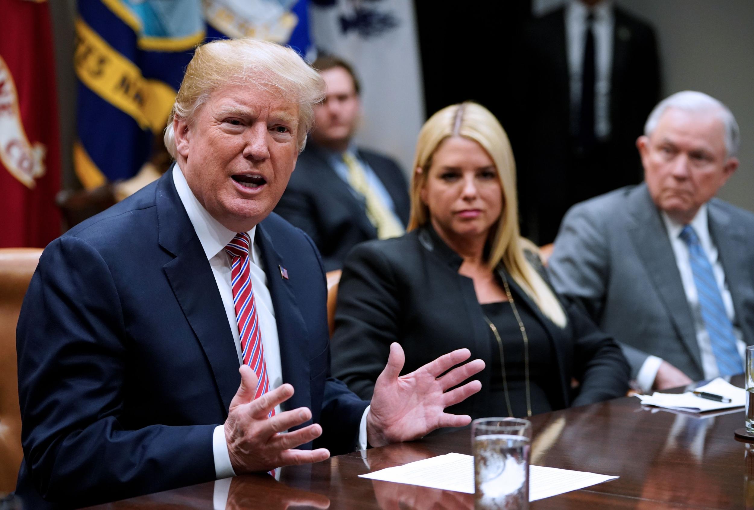 Mr Trump during a meeting at the White House alongside Florida Attorney General Pam Bondi and US Attorney General Jeff Sessions