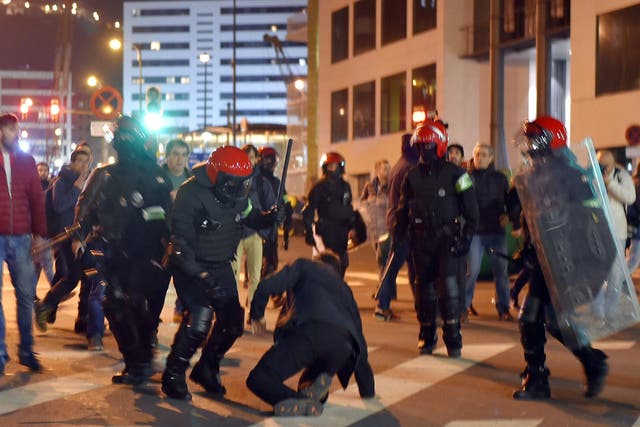 Fans and police clash outside the San Mames Stadium