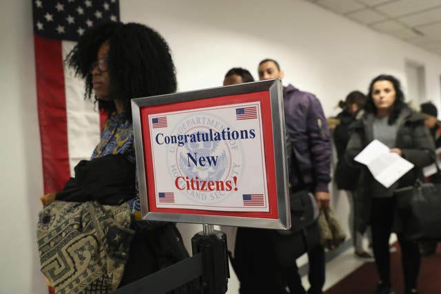 Immigrants wait in line to become US citizens at a naturalization ceremony at the US Citizenship and Immigration Services