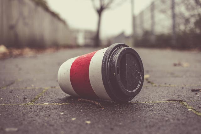 Used coffee cup on a pavement