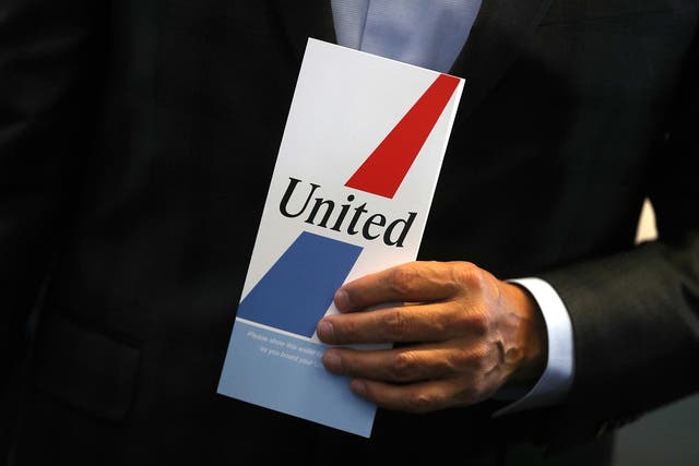 United Airlines CEO Oscar Munoz holds a retro ticket jacket