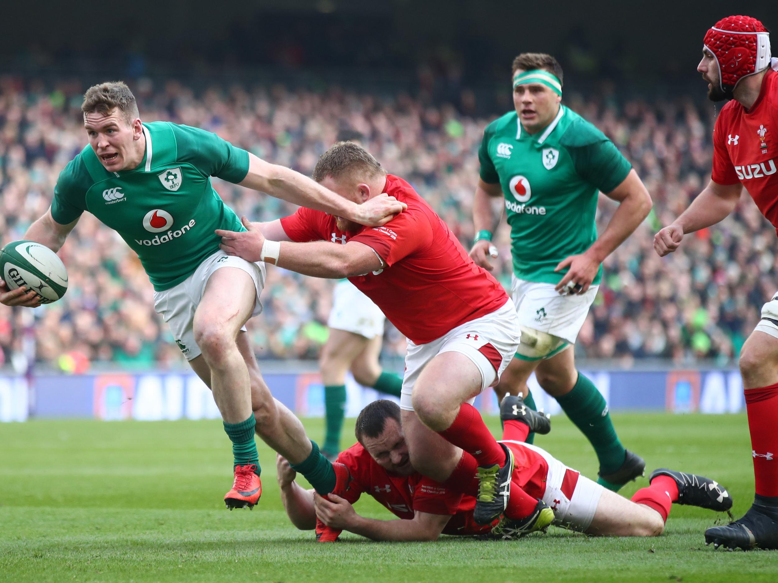 Chris Farrell breaks from the tackle of Samson Lee during Ireland's victory over Wales