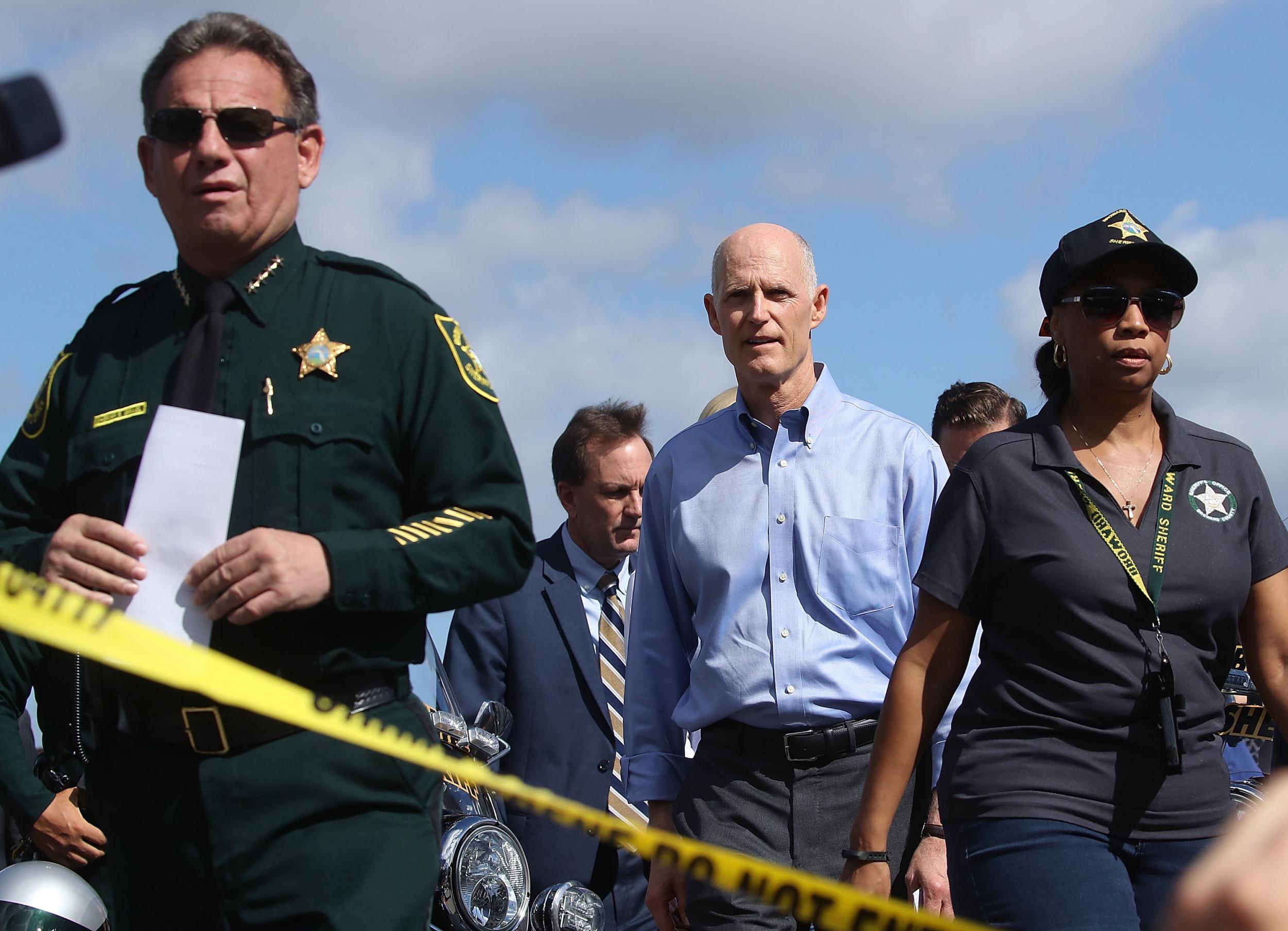 Florida Governor Rick Scott,(R), and Broward County Sheriff, Scott Israel (L), walk up to the media to speak about the mass shooting