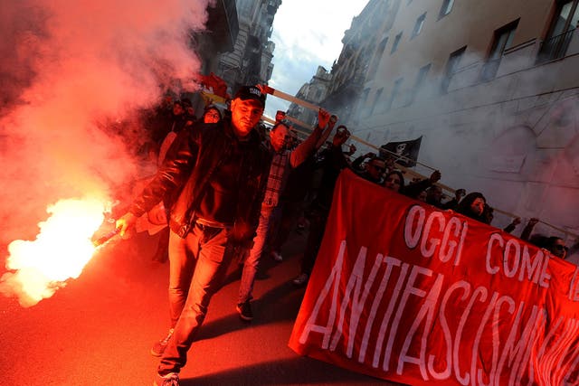 Demonstrators march lighting flares during an anti-fascism demonstration in Palermo