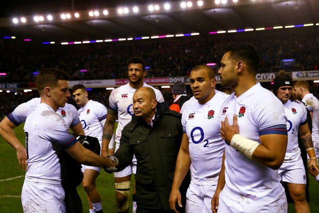 Eddie Jones commiserates his players after defeat by Scotland