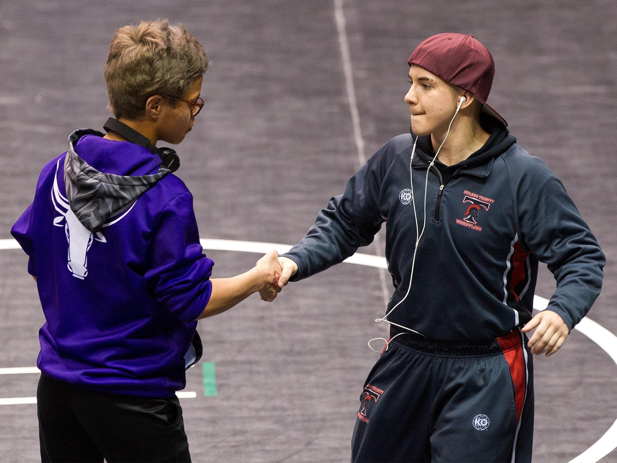 Mack Beggs (right) shakes hands with state championship final opponent Chelsea Sanchez