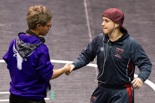 Mack Beggs (right) shakes hands with state championship final opponent Chelsea Sanchez