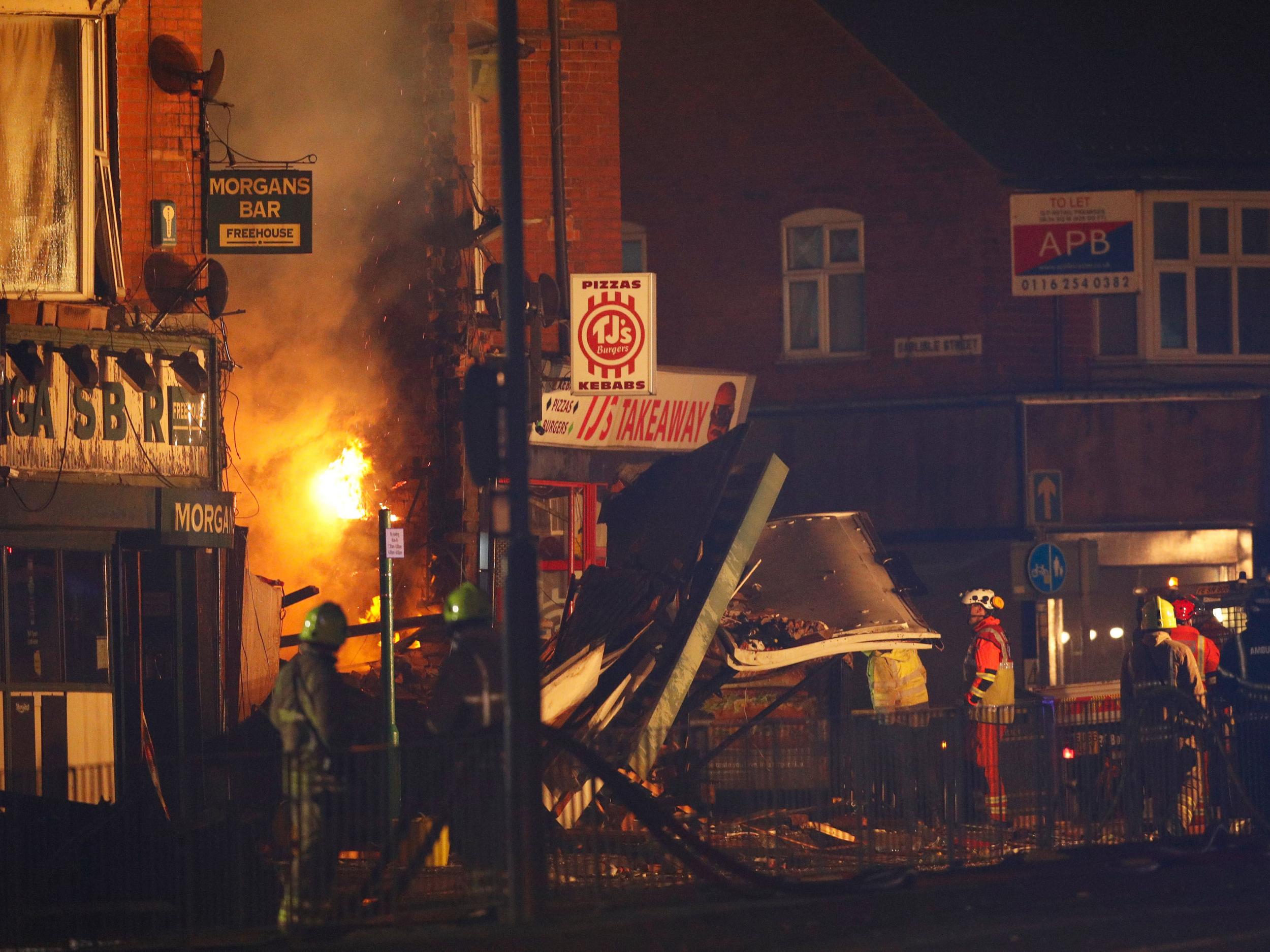 Members of the emergency services work at the site of an explosion which destroyed a convenience store and a home in Leicester (REUTERS/Darren Staples)