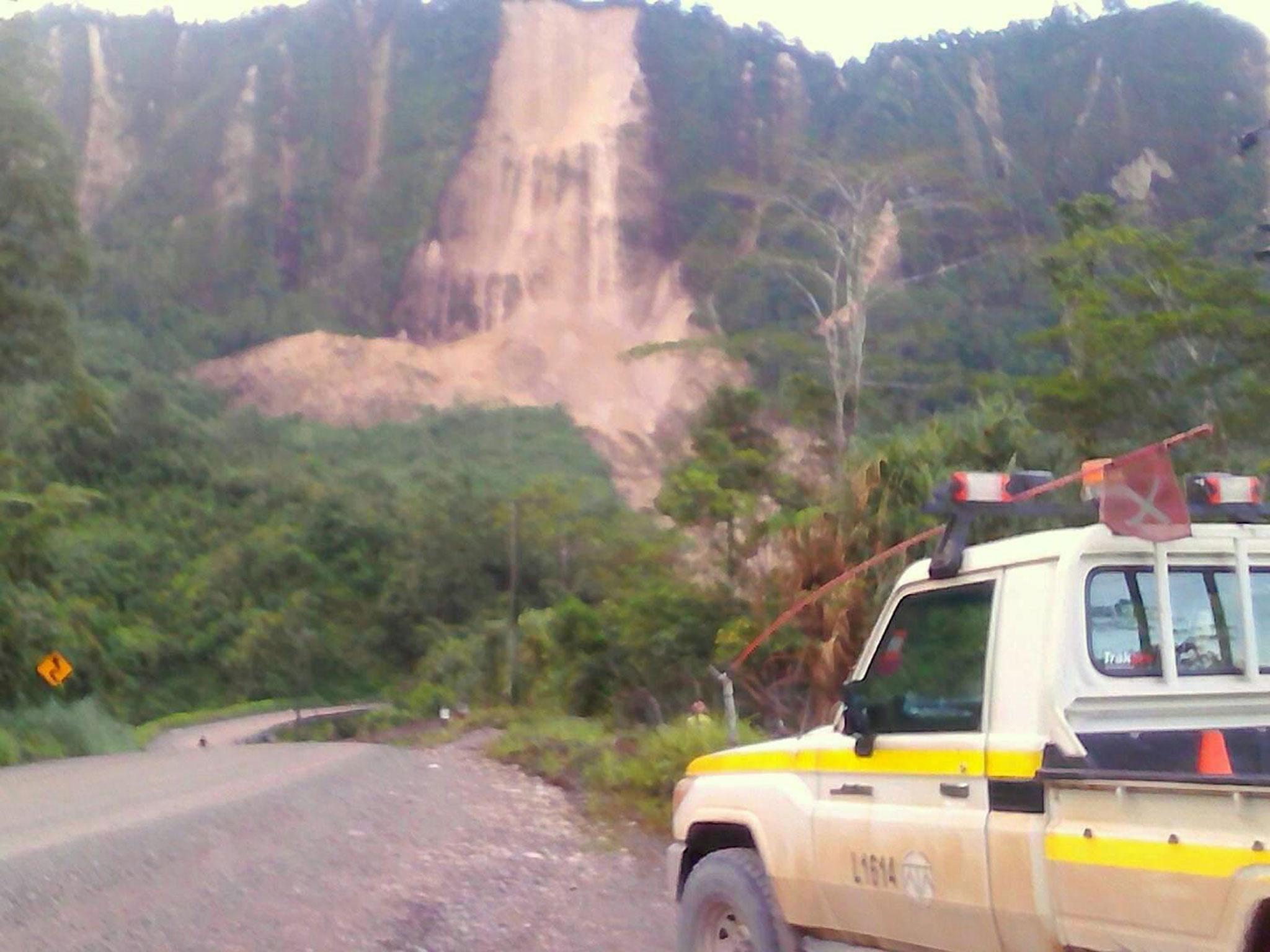 Locals near Tabubil inspect a landslide and damage to a road after a major earthquake struck Papua New Guinea's Southern Highlands