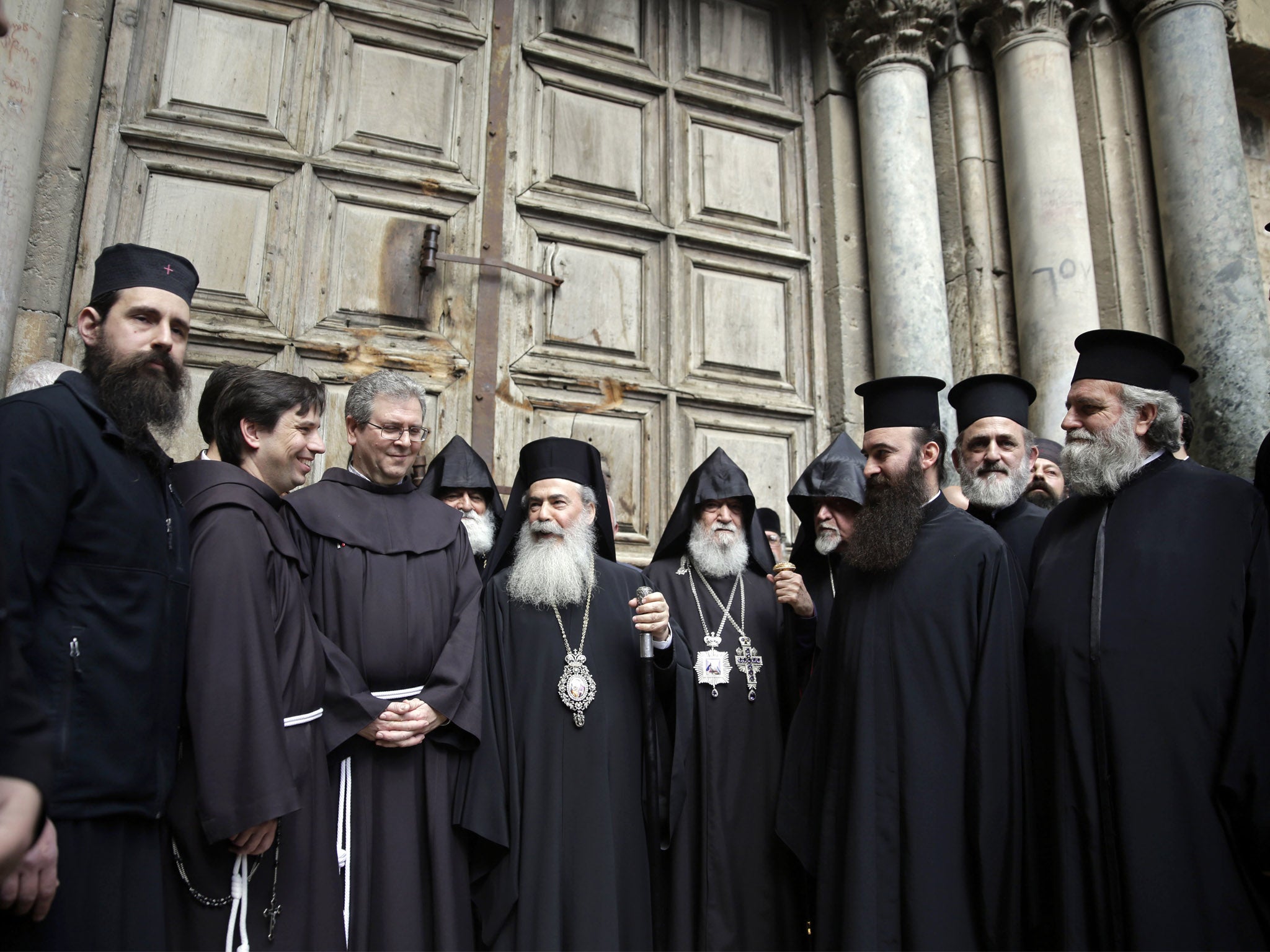 Greek Orthodox Patriarch Theophilos III stands outside the closed doors of the Church of the Holy Sepulchre