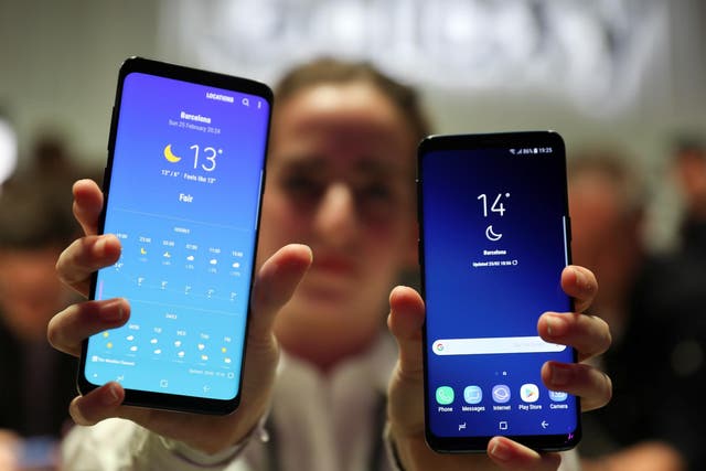 A hostess shows up Samsung's new S9 (R) and S9 Plus devices after a presentation ceremony at the Mobile World Congress in Barcelona, Spain February 25, 2018
