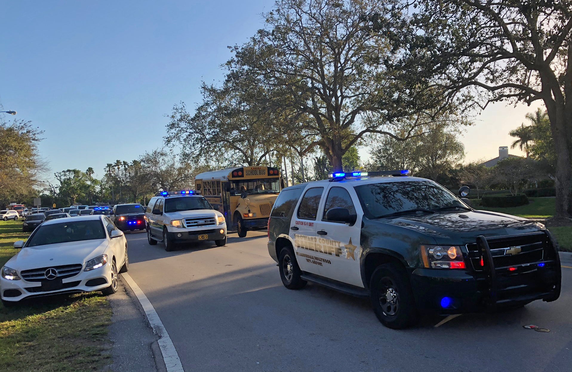 Police and security vehicles are seen at Marjory Stoneman Douglas High School in Parkland, Florida, following a school shooting