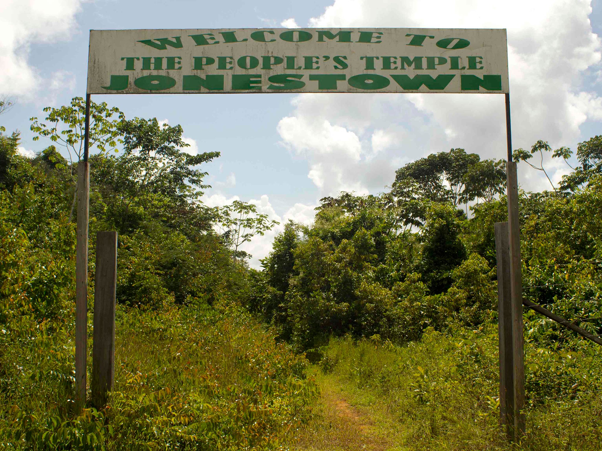 A sign marks the entrance of the former Jonestown temple deep in the Guyanese rainforest.
