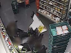 CCTV shows masked robbers tying up supermarket staff in Barnet