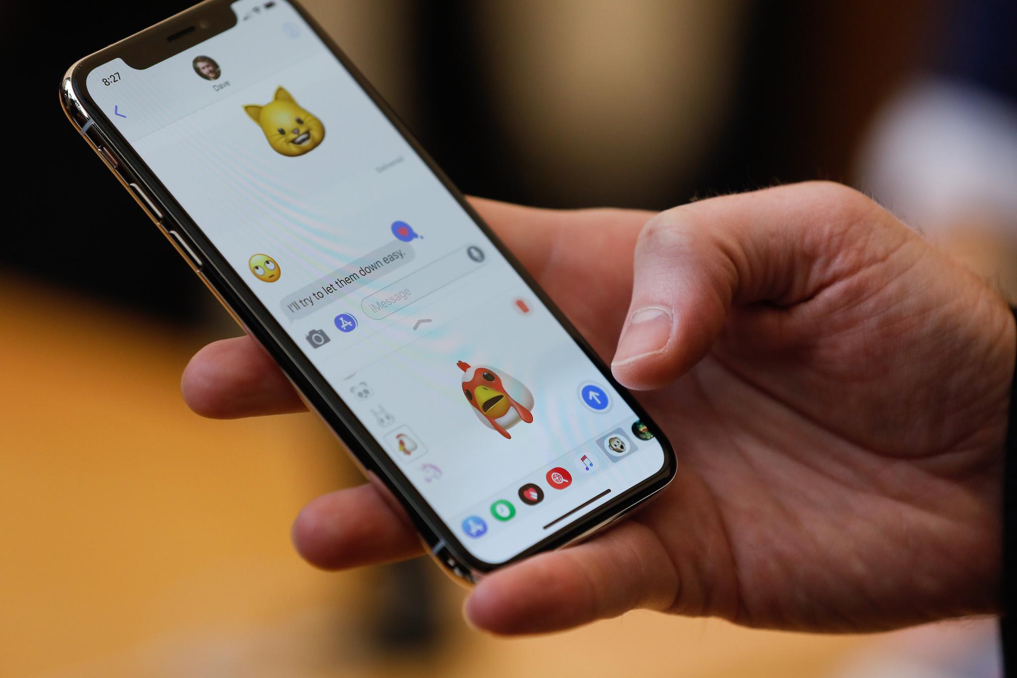 An Apple employee demonstrates the Animoji feature on the new iPhone X at the Apple Store Union Square on November 3, 2017, in San Francisco, California