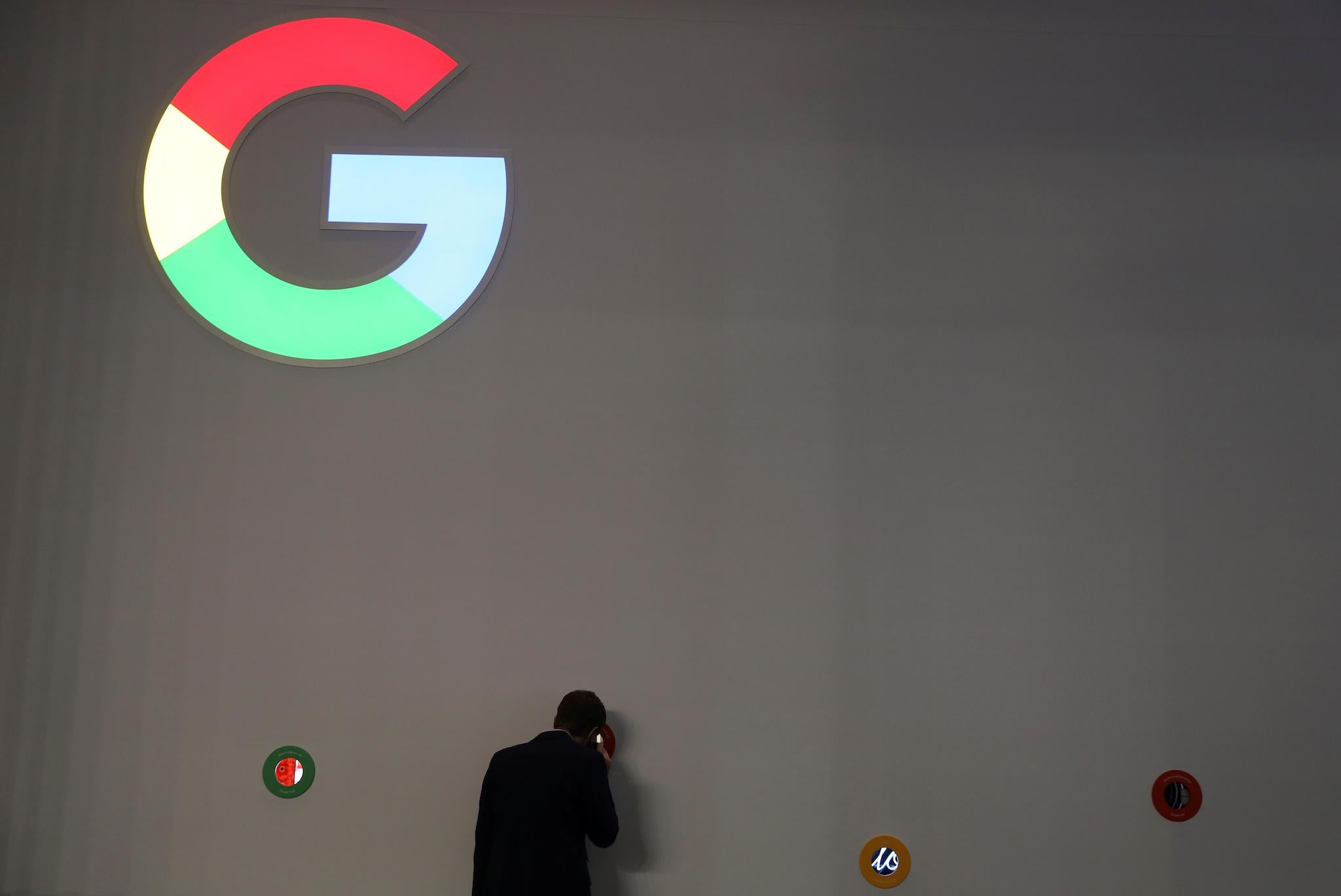 A man checks Google devices outside the tech giant's booth at the Mobile World Congress in Barcelona, Spain