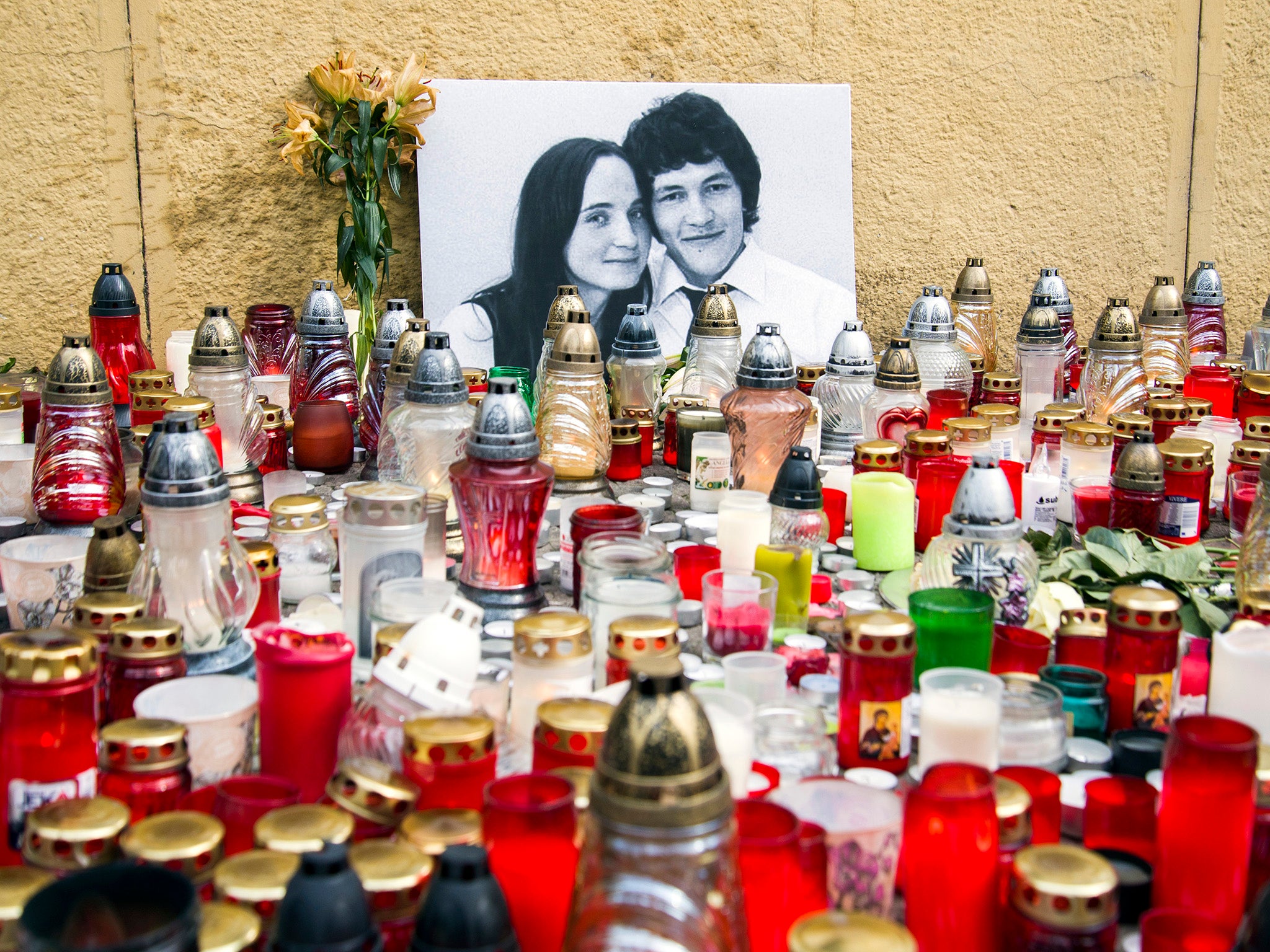 Candles are left in tribute to murdered Slovakian investigative reporter Jan Kuciak, 27, and his fiancee, Martina, 27, at Slovak National Uprising Square in Bratislava