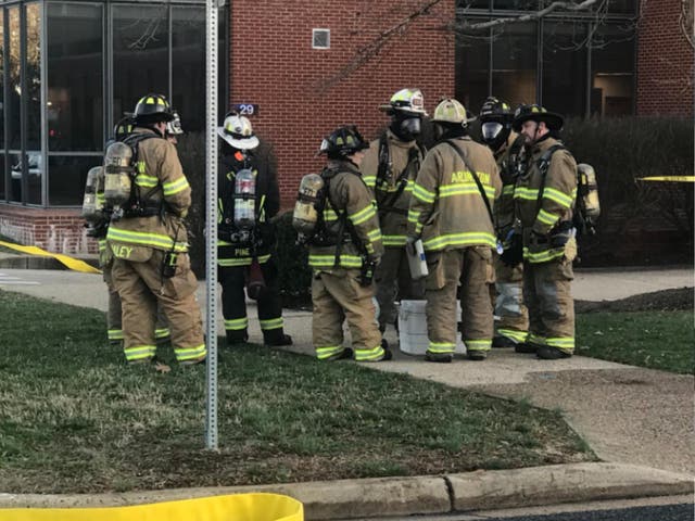 A hazardous materials (Hazmat) team enters a building at Fort Myer-Henderson Hall military base in Arlington, Virginia, after a suspicious letter made 11 people sick on 27 February 2018