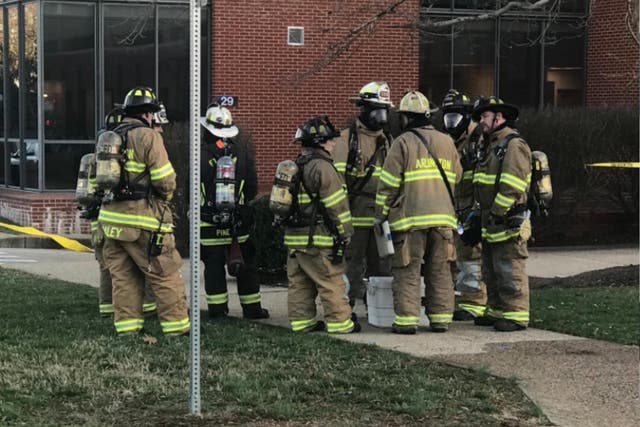 A hazardous materials (Hazmat) team enters a building at Fort Myer-Henderson Hall military base in Arlington, Virginia, after a suspicious letter made 11 people sick on 27 February 2018