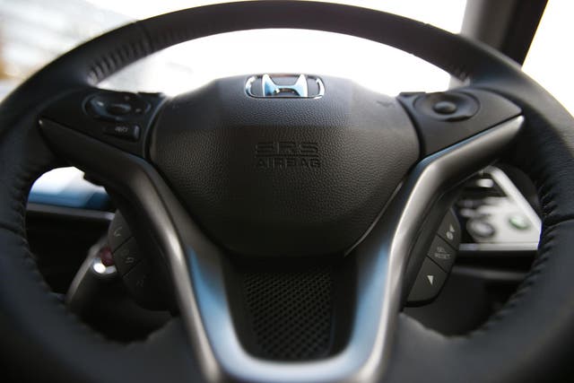 An airbag logo is seen on a steering wheel of Honda, one of the cars affected by the product recall